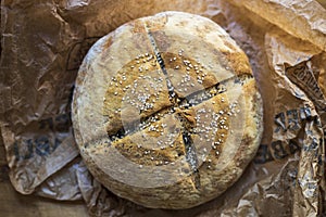 Loaf of homemade bread on a brown wood table