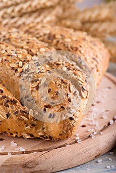 Loaf of multicereal bread on wooden board