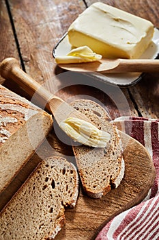 Loaf of rye bread with cut slices on a board