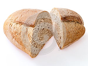 Loaf of rye bread cut in two pieces. Close up, on white
