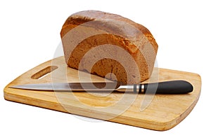 Loaf of rye bread and knife on cutting board on white background