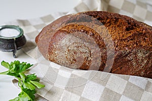 Loaf of rye bread on linen napkin.Selective focus.