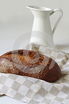 Loaf of rye bread on linen napkin.Selective focus.