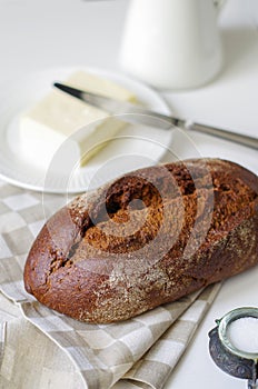 Loaf of rye bread on linen napkin.Selective focus.