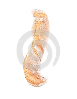 A loaf of s-shaped bread sprinkled with flour on white background