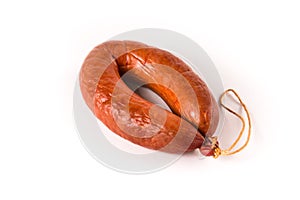 Loaf of sausage bandaged with string on a white background isolated.