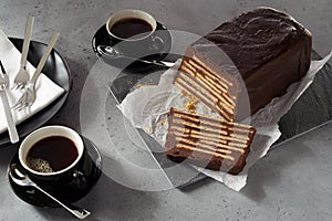 Loaf-shaped chocolate biscuit cake and coffee