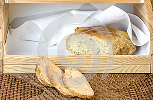 loaf of sliced white artisan bread, on the table in the breadbasket