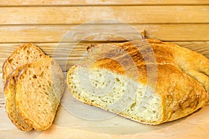 Loaf of sliced white artisan bread, on the table near the breadbasket