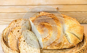 Loaf of sliced white artisan bread, on the table near the breadbasket