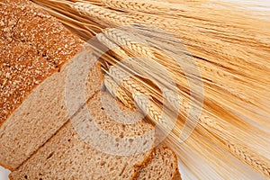 Loaf of wheat bread and shocks of wheat