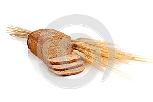Loaf of wheat bread and shocks of wheat