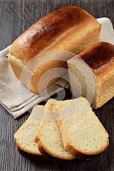 A loaf of wheat bread with slices