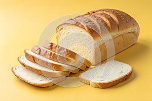 bread slices loaf soft tmixtrue on yellow background. photo