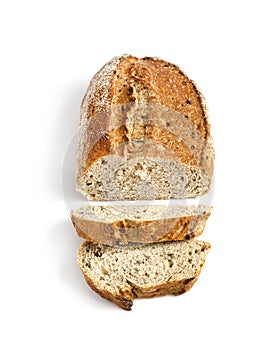 Loaf of whole wheat bread with slices isolated on white