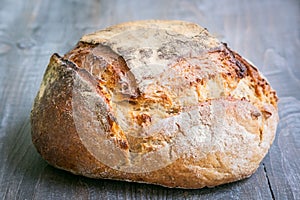 Loafs or miche of French sourdough, called as well as Pain de campagne, on display on a wooden table.