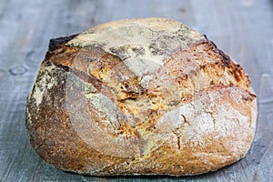 Loafs or miche of French sourdough, called as well as Pain de campagne, on display on a wooden table.