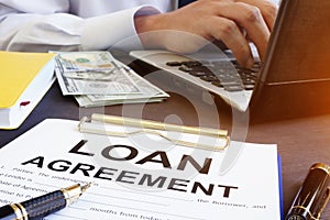 Loan agreement and money on a desk.