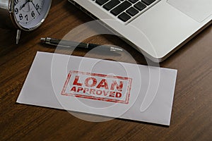 Loan approved word by rubber stamping on envelope.Loan business finance economy commercial real estate investments concept