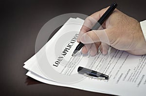 Loan Contract Document on Desk with Black Pen