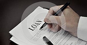 Loan Contract Document on Desk with Black Pen