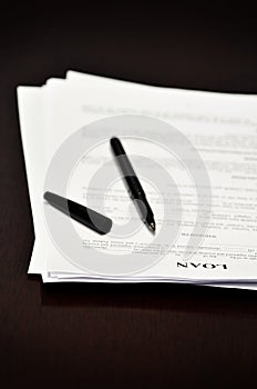 Loan Contract Document on Desk with Black Pen