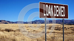 Loan denied brown road sign