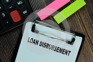 Loan Disbursement write on a paperwork isolated on Wooden Table. Finance concepts