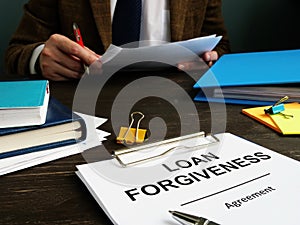 Loan forgiveness form and man checks documents