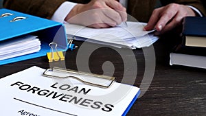 Loan forgiveness form for signing and manager works with papers.