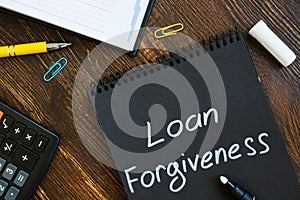 Loan forgiveness note on notepad page.