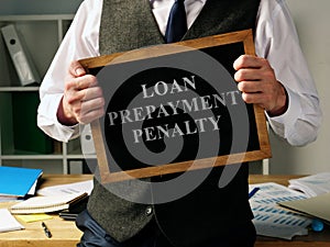 Loan Prepayment Penalty. Man is holding blackboard photo