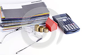 Loans concept with Bill payment and calculator and coins and house paper and eyeglsses
