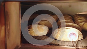 Loaves of bread are baked in an oven in production