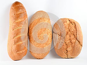 Loaves of bread isolated on white background. Wheat, rye, bread with sesame seeds