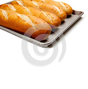 Loaves of french bread on a baking sheet