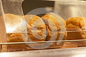 Loaves of fresh bread on the counter in a store. Traditional delicious pastries. Close-up