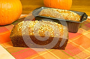 Loaves of pumpkin bread with pumpkins