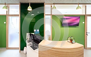 Lobby entrance with reception desk in a dental clinic
