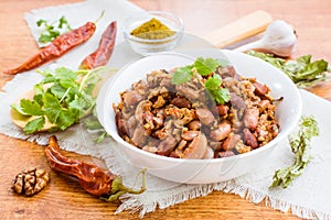 Lobio - the national Georgian dish of beans in a white plate and the ingredients for its preparation