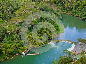 Loboc River with waterfall in Bohol island, Philippines. Aerial drone view photo