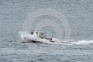 Lobster boat digging into oncoming wake