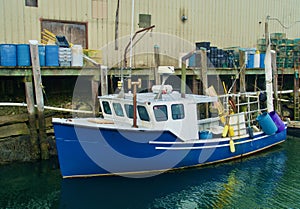Lobster boat moored alongside wharf