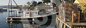 Lobster boat and traps on wharf