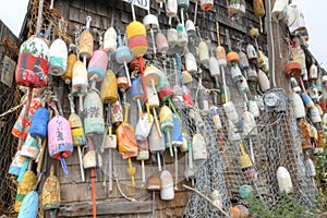 Lobster buoys of various color on shack
