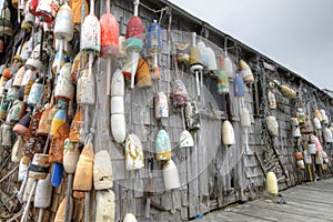 Lobster buoys of various color on shack