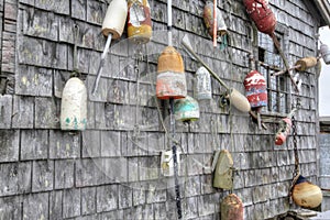 Lobster buoys of various color on shack