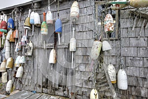 Lobster buoys of various color on shack