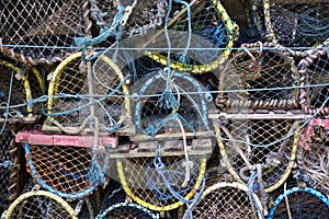 Lobster and crab fish pots netted boxes stacked in harbour