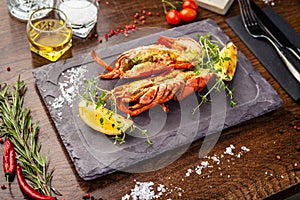 Lobster with flavored butter. Herb butter, lemon. Delicious healthy traditional food closeup served for lunch in modern